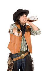 Image showing Cowboy drinking whiskey from the bottle