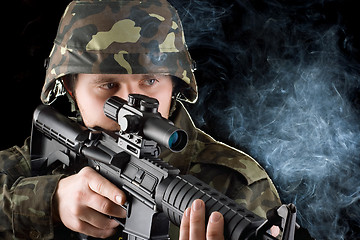 Image showing Soldier with the smoking gun. Closeup