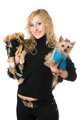 Image showing Portrait of smiling young blonde with two dogs