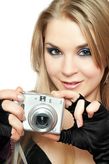 Image showing Smiling beautiful woman holding a photo camera