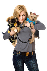 Image showing Smiling young blonde posing with two dogs