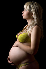 Image showing Pregnant girl in yellow lingerie. Isolated