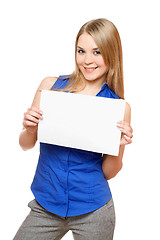 Image showing Cheerful young woman holding empty white board