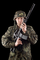 Image showing Alerted soldier raised m16 in studio