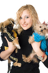 Image showing Portrait of smiling beautiful blonde with two dogs. Isolated