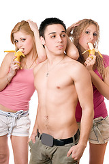 Image showing Young man and two pretty women with bananas