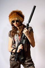 Image showing Beautiful armed girl in hat