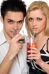 Image showing Beautiful young couple with cocktails. Isolated