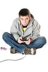 Image showing Young man with a joystick for game console. Isolated