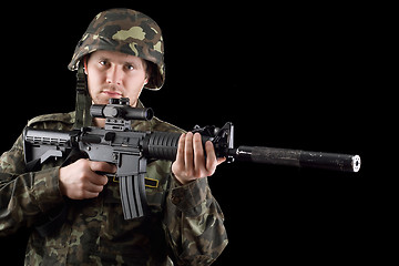 Image showing Alerted soldier holding m16