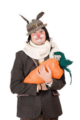 Image showing Portrait of young man with carrot