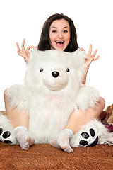 Image showing Joyful girl plays with a teddy bear