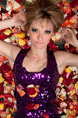 Image showing sensual young blonde lying in rose petals