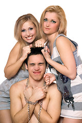 Image showing Two playful blonde and a guy in chains