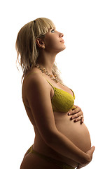 Image showing Happy pregnant young woman in yellow lingerie