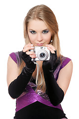 Image showing Young attractive blonde holding a photo camera. Isolated