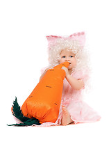 Image showing Baby girl plays with a carrot