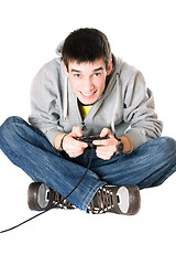 Image showing Young man with a joystick for game console