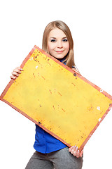 Image showing Smiling young woman posing with yellow vintage board