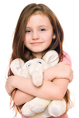 Image showing Portrait of smiling little girl with a teddy elephant