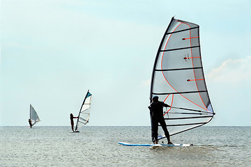 Image showing Silhouettes of a three windsurfers