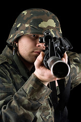 Image showing Alerted soldier pointing m16 in studio