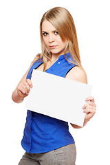 Image showing Serious young woman holding empty white board