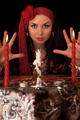 Image showing Witch at the table with candles. Isolated 