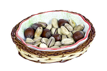 Image showing hazelnuts and pistachios in a wicker basket