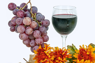 Image showing red grapes with a glass of wine