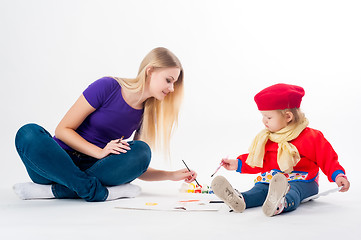 Image showing Pretty young mother and daughter drawing