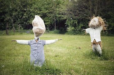 Image showing Two straw scarecrows