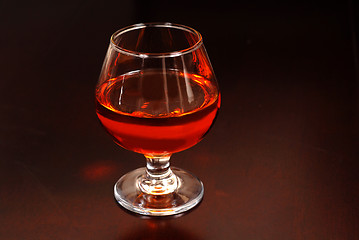 Image showing Warming snifter of Amaretto liquor on a table