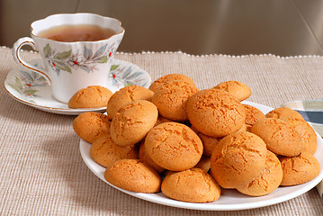 Image showing Plate of crisp Italian Amaretti cookies with a cup of hot tea in