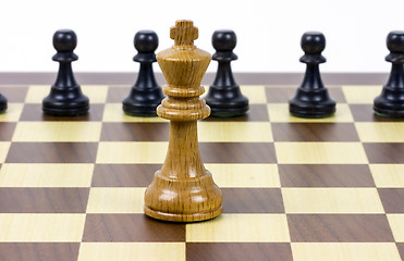 Image showing chess king against pawns