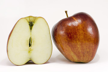 Image showing A ripe red apple and half apple