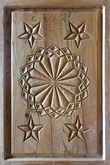 Image showing floral tars motifs carved on the old wooden doors.