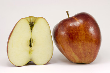 Image showing A ripe red apple and half apple
