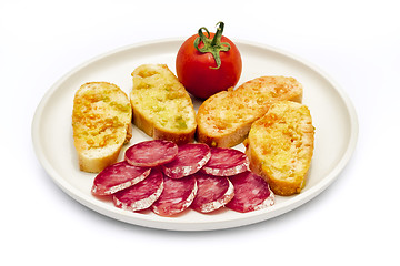 Image showing tomato rubbed on a slice of bread