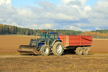 Image showing Tractor and Agricultural Trailer on Flax Field