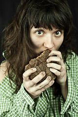 Image showing poor beggar woman eating bread