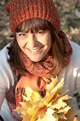 Image showing woman with autumn orange leaves