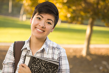 Image showing Portrait of a Pretty Mixed Race Female Student Holding Books