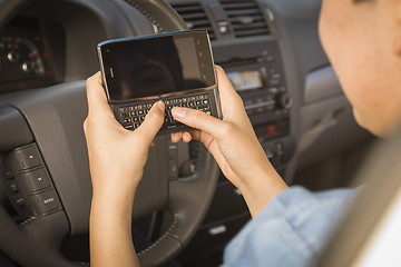 Image showing Mixed Race Woman Texting and Driving