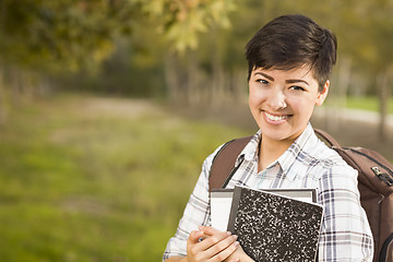 Image showing Portrait of a Pretty Mixed Race Female Student Holding Books