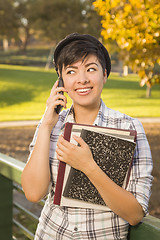 Image showing Mixed Race Female Student Holding Books and Talking on Phone