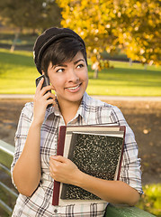 Image showing Mixed Race Female Student Holding Books and Talking on Phone