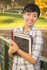 Image showing Portrait of a Pretty Mixed Race Female Student Holding Books