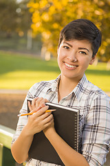 Image showing Portrait of a Pretty Mixed Race Female Student Holding Books