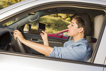 Image showing Mixed Race Woman Texting and Driving